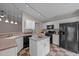 Functional kitchen with modern appliances, an island, and patterned tile flooring at 203 Grassy Point Rd, Apex, NC 27502