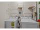A laundry room featuring a white washer and dryer with wire shelving at 203 Grassy Point Rd, Apex, NC 27502