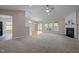 Bright living space with a fireplace, large windows, and seamless flow to the dining area at 203 Grassy Point Rd, Apex, NC 27502