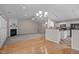 Combined living and kitchen area with a fireplace, granite countertops, and modern appliances at 203 Grassy Point Rd, Apex, NC 27502