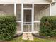A close-up of the screened-in porch reveals a tranquil outdoor space with trimmed shrubs at 203 Grassy Point Rd, Apex, NC 27502