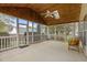Relaxing screened porch with a ceiling fan, wood paneling, and views of the backyard at 203 Grassy Point Rd, Apex, NC 27502