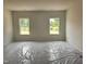 Bedroom with two windows, the floors are covered with a protective plastic film at 21 Mildred Pl, Broadway, NC 27505