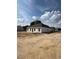 Rear view of a single-story home featuring white siding and a spacious yard at 21 Mildred Pl, Broadway, NC 27505