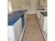 Newly installed kitchen cabinets and countertops are protected with a blue plastic film at 21 Mildred Pl, Broadway, NC 27505