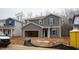 Two-story home with gray siding, an attached two-car garage, and manicured front lawn at 2124 Cherry Creek Rd, Haw River, NC 27258