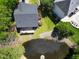 Birds-eye view of home featuring patio, back yard pond and well manicured landscaping at 219 Arbordale Ct, Cary, NC 27518