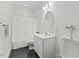 Well lit all white bathroom featuring modern toilet, tile floors and sleek vanity at 219 Arbordale Ct, Cary, NC 27518