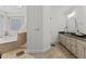 Bathroom featuring double sink vanity, walk-in shower and stand alone tub at 219 Arbordale Ct, Cary, NC 27518