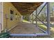 View of a deck supported by wood framing with a stone covered ground level patio at 219 Arbordale Ct, Cary, NC 27518