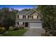 Charming two-story brick home with a well-manicured lawn, attached garage, and inviting front porch at 219 Arbordale Ct, Cary, NC 27518