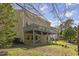 Exterior view of house featuring deck, beautiful lawn and wooded scenery at 219 Arbordale Ct, Cary, NC 27518