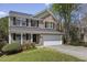Charming brick home with a well-manicured lawn, black shutters, and attached two car garage at 219 Arbordale Ct, Cary, NC 27518