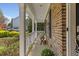 Charming brick home featuring a welcoming front porch, perfect for relaxing and enjoying the outdoors at 219 Arbordale Ct, Cary, NC 27518