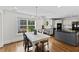 Spacious kitchen and dining area with a large window and granite countertops, perfect for Gathering meals at 219 Arbordale Ct, Cary, NC 27518
