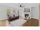 Inviting living room with a fireplace, ceiling fan, hardwood floors and plenty of natural light at 219 Arbordale Ct, Cary, NC 27518
