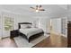 Serene main bedroom featuring tray ceilings, hardwood floors, and ensuite bath access at 219 Arbordale Ct, Cary, NC 27518