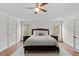 Spacious bedroom with a ceiling fan, hardwood floors, and abundant natural light, ensuring a peaceful night's sleep at 219 Arbordale Ct, Cary, NC 27518