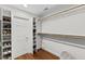 Walk-in closet featuring custom shelving, wooden racks, and neutral paint at 219 Arbordale Ct, Cary, NC 27518