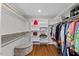 Spacious walk-in closet features custom shelves, hanging rods, and hardwood floors at 219 Arbordale Ct, Cary, NC 27518