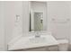 Bathroom features a white sink, quartz countertops, and a mirror at 2202 Cherry Creek Rd, Haw River, NC 27258