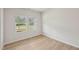 Bright and airy bedroom with wood-look floors and natural light from the window at 2202 Cherry Creek Rd, Haw River, NC 27258
