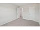 This bedroom features neutral walls, gray carpet, and a closet for ample storage space at 2202 Cherry Creek Rd, Haw River, NC 27258