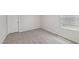 This bedroom features neutral walls, gray carpet, and a window providing natural light at 2202 Cherry Creek Rd, Haw River, NC 27258
