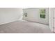 Bright bedroom featuring neutral walls, carpeting, and natural light from two windows at 2202 Cherry Creek Rd, Haw River, NC 27258