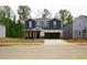 New two-story home featuring a gray exterior, two car garage and a well-manicured lawn at 2202 Cherry Creek Rd, Haw River, NC 27258