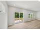 Living room featuring wood floors, neutral paint, recessed lights, a sliding glass door to the patio, and large windows to let in natural light at 2202 Cherry Creek Rd, Haw River, NC 27258