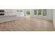 Open concept living room, kitchen, dining room, featuring wood floors, recessed lights, neutral paint, and large windows to let in natural light at 2202 Cherry Creek Rd, Haw River, NC 27258
