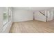 Spacious living room features wood floors, recessed lights, neutral paint, and access to the staircase at 2202 Cherry Creek Rd, Haw River, NC 27258