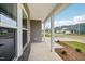 Inviting front porch with white columns, offering a view of the neighborhood at 2202 Cherry Creek Rd, Haw River, NC 27258