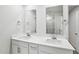 Double vanity bathroom with dual mirrors, modern fixtures, and white cabinets at 2206 Cherry Creek Rd, Haw River, NC 27258