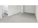 Bright bedroom featuring neutral walls, carpet flooring, and a bathroom entrance at 2206 Cherry Creek Rd, Haw River, NC 27258