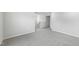 Bright, carpeted bedroom featuring neutral walls and a view of the staircase at 2206 Cherry Creek Rd, Haw River, NC 27258