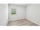 Bright bedroom with a window view and wood-look floors at 2206 Cherry Creek Rd, Haw River, NC 27258