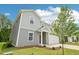 Charming two-story home featuring gray siding, a red front door, an attached garage, and landscaped front yard at 2206 Cherry Creek Rd, Haw River, NC 27258