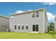 Back exterior of home with sliding door to patio and green lawn at 2206 Cherry Creek Rd, Haw River, NC 27258