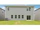 Back exterior of home with sliding door to patio and green lawn at 2206 Cherry Creek Rd, Haw River, NC 27258