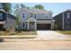 Charming two-story home featuring a two-car garage, well-manicured lawn, and classic architectural details at 2206 Cherry Creek Rd, Haw River, NC 27258