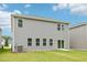 Back exterior of home with sliding door to patio and green lawn at 2206 Cherry Creek Rd, Haw River, NC 27258