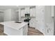 Bright kitchen with an island, stainless steel appliances, white cabinets, and white countertops at 2206 Cherry Creek Rd, Haw River, NC 27258