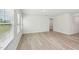 Bright, open-concept living room with light-colored flooring and natural light from the windows at 2206 Cherry Creek Rd, Haw River, NC 27258