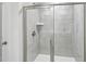 Modern walk-in shower featuring tile surround, glass doors, and a shower head at 2206 Cherry Creek Rd, Haw River, NC 27258