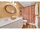 Bathroom featuring a double sink vanity, a framed mirror, and a patterned shower curtain at 2208 Walden Creek Dr, Apex, NC 27523
