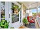 Cozy front porch with chairs, plants, and a decorative wreath on the door at 2208 Walden Creek Dr, Apex, NC 27523