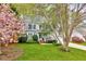 Charming two-story home with well-manicured lawn and flowering trees at 2208 Walden Creek Dr, Apex, NC 27523