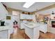 Open kitchen with white cabinets, island, and modern appliances at 2208 Walden Creek Dr, Apex, NC 27523